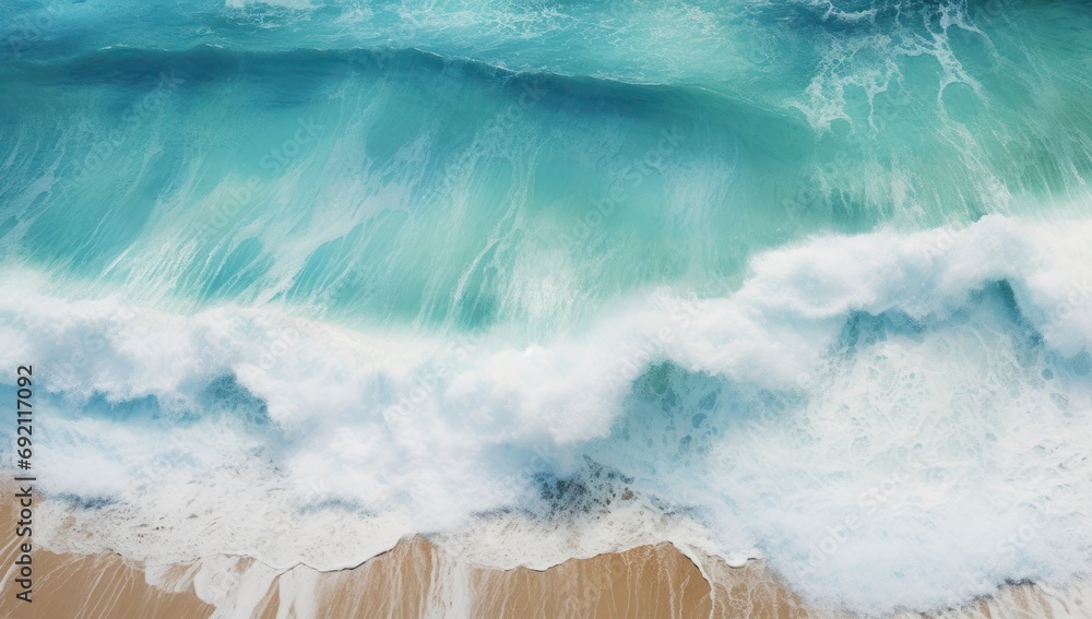 Poster an aerial view of a wave crashing on a sandy beach with a surfboard in the foreground and the ocean 