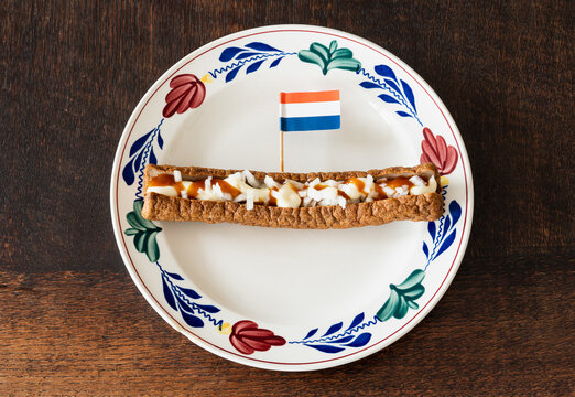 Frikandel speciaal, a traditional dutch fast food snack consisting of minced meat sausage, mayonnaise, curry and chopped raw onion