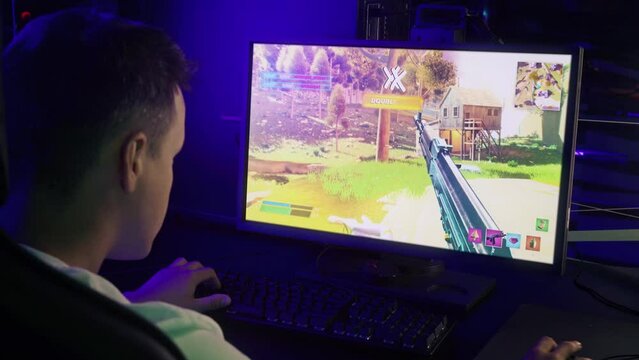 Gamer having fun in the first person shooter internet computer fake game. Gamer killing the enemies in the round of a fake game. Gamer dying to the opponent shot in the fake esports video game.