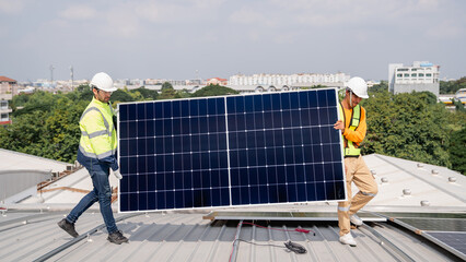 Service engineer installing solar cell on the roof of factory. Technicians working about solar...