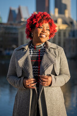 Happy smiling female model with strong unique style appearance in urban inner city environment The...