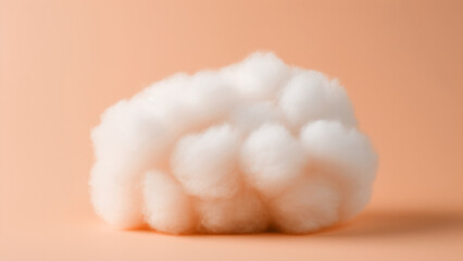 A fluffy white cotton ball on peach fuzz color minimal background. Modern trendy tone hue shade