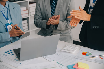 Financial analysts analyze business financial reports on a digital tablet planning investment...