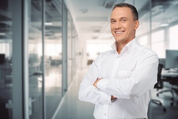 Handsome business man smiling in office background