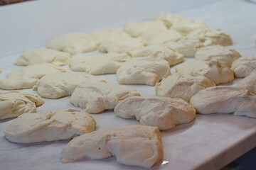 Dough divided into individual pieces on the table