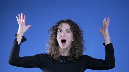 Funny Woman Mimicking Head Explosion on Blue Background, Shocked Yet Amused having a breakthrough...