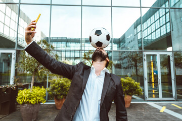 Businessman playing with a soccer ball and making freestyle tricks