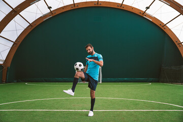 Cinematic image of a soccer freestyle player making tricks with the ball.