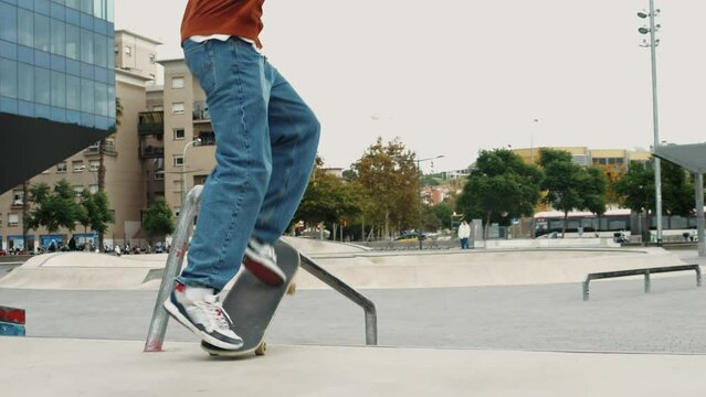 Young skater making 360 flip jump, performing kickflip trick, skateboarder training in skatepark, making tricks, slides and flips, professional extreme sport athlete training ride on skateboard. 