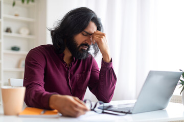Tired Indian Freelancer Suffering Eyes Fatigue While Working With Laptop At Home