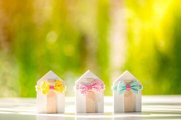 Many home model tied with bow gift are lined up to present and choose to buying for owner house as...