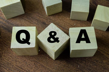 Concept of The wooden Cubes with the word Q&A on white background.