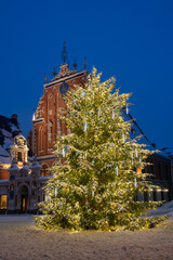 Decorated Christmas tree in the Town Hall Square, the House of the Blackheads on background. Old...