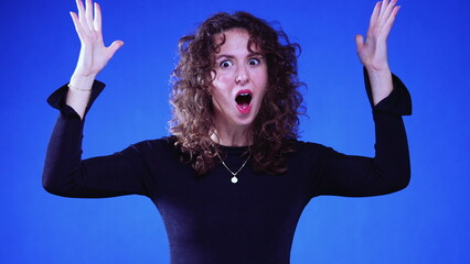 Shocked Female Experiencing Eureka Moment with Explosive Gesture on Blue background