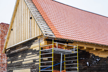 Restoration of a ancient wooden house, clay tile roof and damaged part of walls replacement