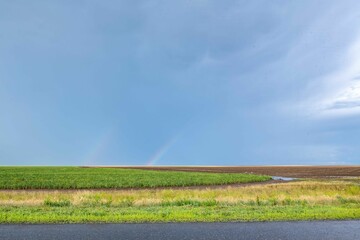 Double bright rainbow after rain in summer in steppe