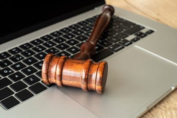 Gavel of justice on laptop keyboard