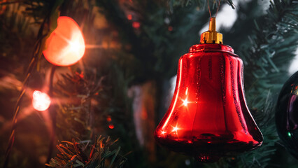 Christmas tree with red bell, heart-shaped lighted ornament and Defocused Lights Background....
