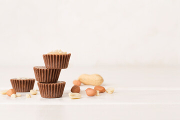 Tasty chocolate peanut butter cups on wooden table