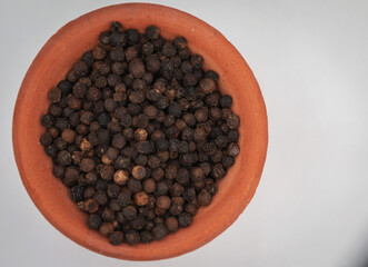 black pepper, in a clay bowl, isolated, white background,