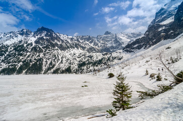 Winter Mountain landscape of Morskie oko in Tatra national park. Icy Sea Eye lake in Tatra mountains - obrazy, fototapety, plakaty