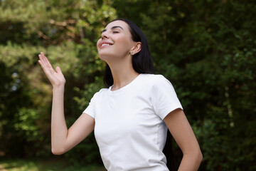 Feeling freedom. Happy woman enjoying nature outdoors