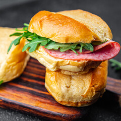 sandwich bun, sausage, salami, arugula, green lettuce ready to eat cooking appetizer meal food snack on the table