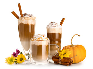 Glasses of tasty pumpkin latte with cinnamon and beautiful flowers on white background