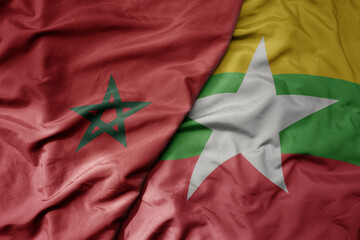 big waving national colorful flag of myanmar and national flag of morocco .