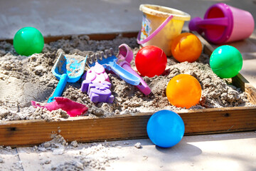 Children's sandbox with various toys for the game in summer day
