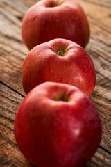 Fresh red apples on a wooden board