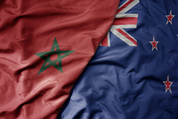 big waving national colorful flag of new zealand and national flag of morocco .