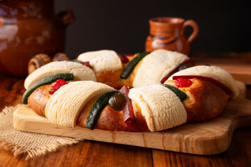 Three Kings Bread also called Rosca de Reyes, Roscon, Epiphany Cake, traditionally served with hot chocolate in a clay Jarrito. Mexican tradition on January 5th. - 692194476