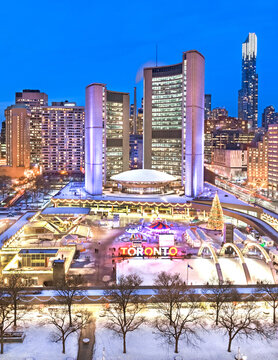 Night time view of Toronto City Hall and staking rink at Nathan Philips Square in winter