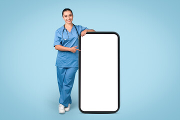 Nurse in blue uniform presenting a blank phone screen