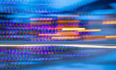 abstract blur of colorful christmas lights with horizontal motion blur special effect created by...