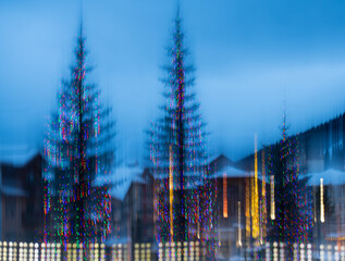 abstract blur of colorful christmas lights with blurry trees in background special effect created...