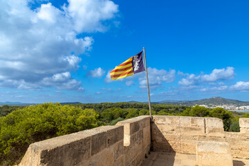 Flagge von Mallorca auf einem alten Wehrturm im Naturschutzgebiet Punta de n´Amer bei Cala Millor