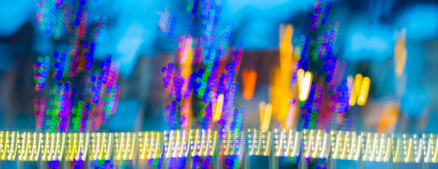 abstract blur of colorful christmas lights with vertical motion blur special effect created by long...