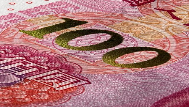 Close-up of intricate patterns and security features on a yuan banknote's surface