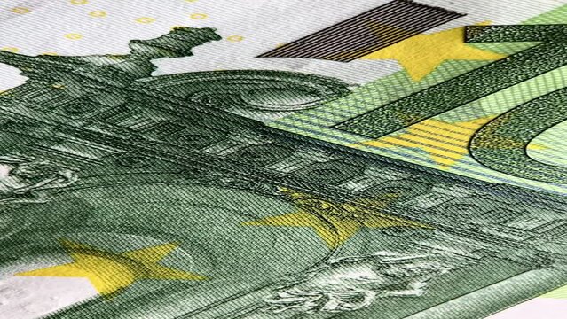 Close-up of a 100 Euro banknote focusing on intricate patterns and security features