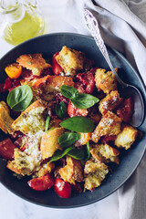 Italian Toscana style salad with ciabatta, tomatoes, bell pepper, parmesan cheese and basil 