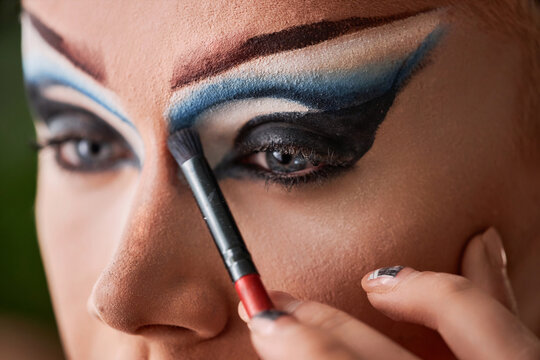 Close up of male performer doing dramatic eye make up, copy space