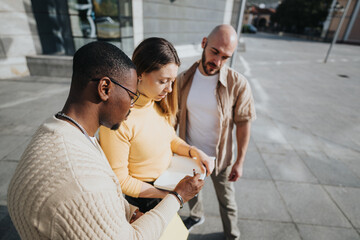 Stylish urban businesspeople strategize business ideas, financial planning, marketing campaign, and...