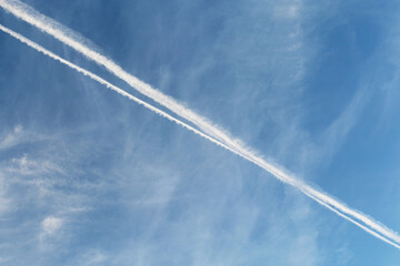 airplane trail in blue clear sky