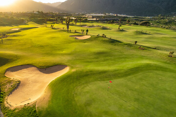 Aerial view of a golf club field at sunset on Tenerife Island, Spain. - obrazy, fototapety, plakaty