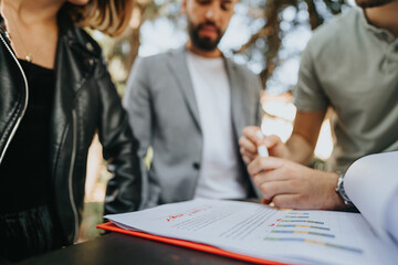 Business professionals in a city area cafe discussing growth, budget, and sales strategy. Their...