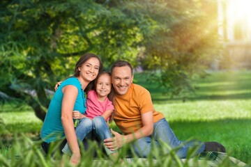 Fototapeta premium Parents with cute child playing in park