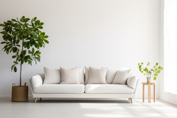 A minimalist living room with a white sofa, beige cushions, a potted plant, and a small wooden table with a vase.