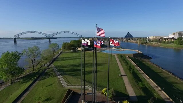 Waving Flags in Mud Island River Park, Memphis, Tennessee. Hernando de Soto Bridge and Mississippi River in Background. Drone